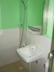 a bathroom with a white sink and a mirror at PG Vacation Rental in Lapu Lapu City