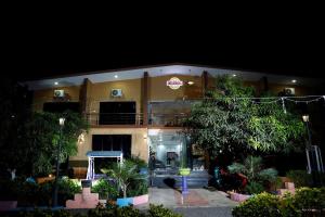 a building at night with trees and plants at Heeran Re-Treat Resort in Sasan Gir +2 photos