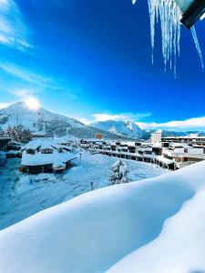 a winter view of a resort with snow on the ground at Hostdomus - Urban Villa in Sestriere