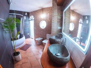 a bathroom with two sinks and two toilets at Casa de piedra en el casco antiguo de Sagunto in Sagunto +39 photos