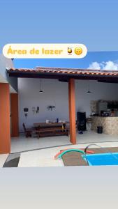 a building with a sign that reads area be longer at casa sol e mar 01 in Paripueira