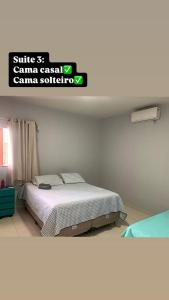 a bedroom with a bed and a sign that reads smile st cameraason camera society at casa sol e mar 01 in Paripueira +20 photos