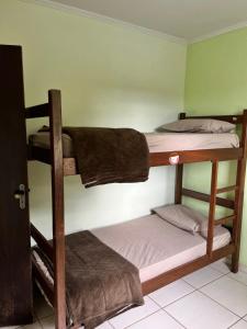 a room with three bunk beds in a room at Casa Vista da Serra in São Roque de Minas