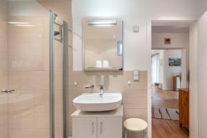 a bathroom with a sink and a glass shower at Ferienwohnung Gaby Lehmann in Hornberg +30 photos