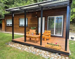 圣卡洛斯-德巴里洛切Tiny House Melgarejo的小屋设有带长凳和桌子的甲板