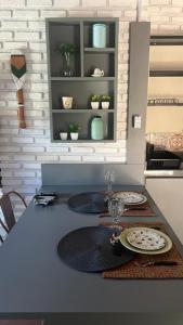 a kitchen counter with two plates on a table at Chalés de Imbassaí - Chalé 4 in Mata de Sao Joao