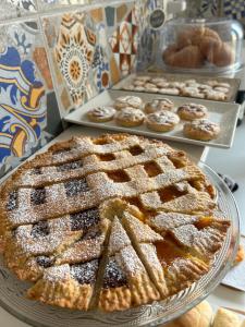 une tarte sur une assiette avec d'autres pâtisseries dans l'établissement La Maison Derrière, à Tropea