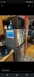 a kitchen with a stainless steel refrigerator with magnets at My apartment in New York +10 photos