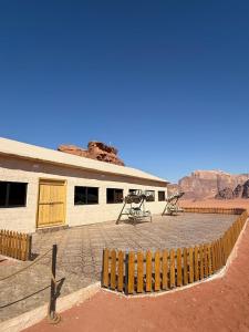 a building with a picnic table in the desert at Khazali Mountain Camp in Wadi Rum