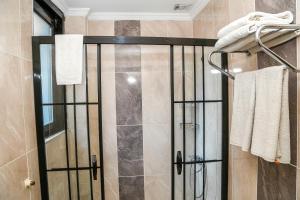 a shower with a glass door in a bathroom at ASİTANE life HOTEL in Istanbul