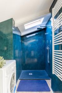 a washer and dryer in a bathroom with blue walls at Via Giunone 1A Bilo in Cervia