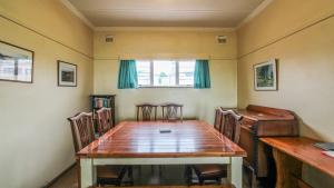 a dining room with a wooden table and chairs at Kimachi in Margate