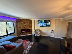 a living room with a couch and a fireplace at Unique 2 Bed, 2 Bath with In & Out Night Skiing in Snowshoe
