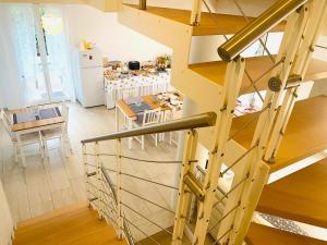 a kitchen and dining room with a staircase and a table at B&B IL NIDO in Cattolica