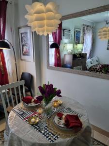 a dining room table with a table cloth and a mirror at Condo for Rent Cheer Residences in Marilao