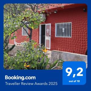 a red house with a sign that says travel review awards at Casa rural Finca Don Amado, San Mateo in Las Palmas de Gran Canaria