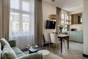 a living room with a couch and a table at Millou - LoftAffair Collection in Kraków