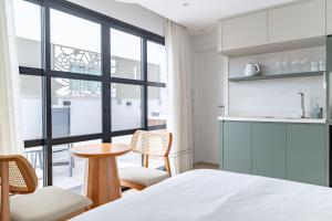a bedroom with a bed and a table and chairs at Up Hotel Boutique in Bombinhas