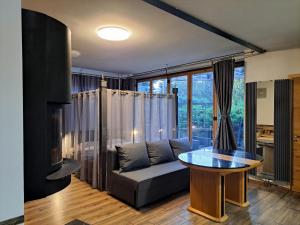 a living room with a couch and a table at Champêtre Park View Apartments in Riga