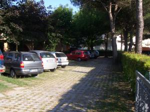 a row of cars parked on the side of a road at Fenice in Bibione