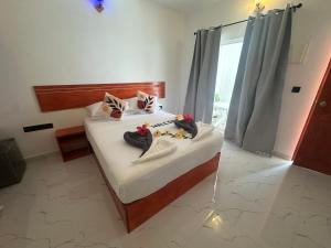Postel nebo postele na pokoji v ubytování Thoddoo Cozy Stay