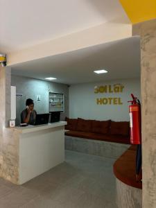 een vrouw aan een balie in een hotellobby bij Sol lar hotel flats in Paragominas