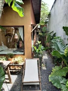 a garden with a chalkboard in front of a house at Floating market cabin in Can Tho