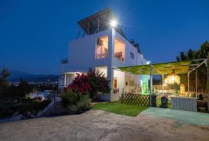 a white house with a light on top of it at White House Chersonisos with Private swimming pool in Limín Khersonísou