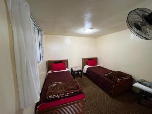a room with two beds and a window at شقة سيلا in Irbid