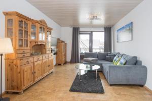 ヴィンターベルクにあるWelcome in - Appartement 59-G Leni naast de piste, met balkon, sauna en zwembadのソファとテーブルのあるリビングルーム