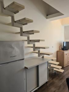 a kitchen with wooden floors and stainless steel appliances at Duplex Family Apartment in Skopje