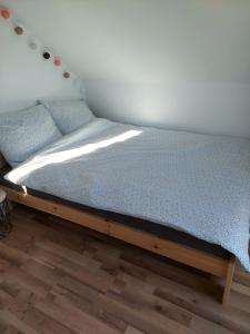 a bed sitting in a corner of a room at Plutowka in Zawoja