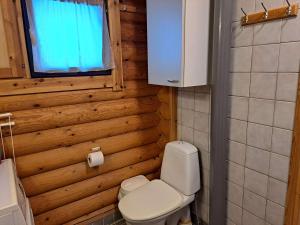 a small bathroom with a toilet and a window at Lomaloukas 1 in Syöte +23 photos