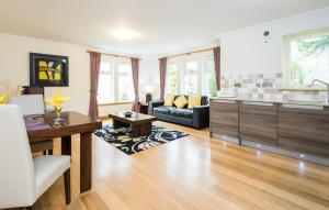 a kitchen and living room with a couch and a table at Claymore Apartments in Pitlochry +17 photos