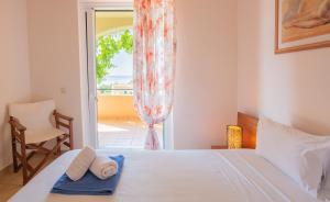 a bedroom with a bed with two towels on it at Barbati Angela's Garden Sea View in Barbati +43 photos