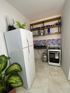 a kitchen with a refrigerator and a microwave at Berenice Concept Residence - By Temporada Expert in Feira de Santana +46 photos