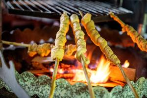 a group of food being cooked on a grill at Nature Dream Days in Muhos +69 photos