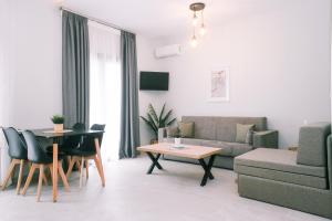 a living room with a couch and a table at Bloom Garden Apartments in Ierissos