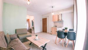 a living room with a couch and a table at Bloom Garden Apartments in Ierissos