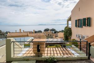 a view of the water from the balcony of a house at Barbati Angela's Garden Sea View in Barbati