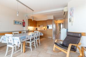 a kitchen and dining room with a table and chairs at Nori TV in Ostend +26 photos