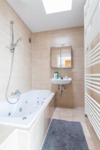 a bathroom with a tub and a sink at Nori TV in Ostend