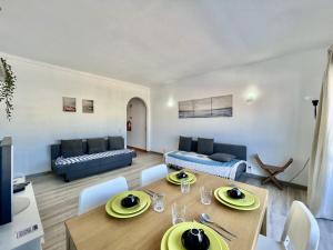 a living room with a table and a couch at Albufeira Classic 2 by Homing in Albufeira