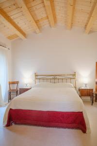 a bedroom with a large bed with a red blanket on it at La Casa di Vina in Fermo