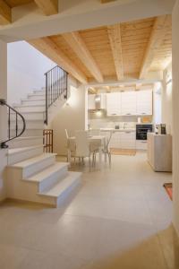 a kitchen and dining room with stairs and a table at La Casa di Vina in Fermo
