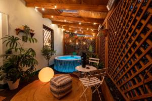 a room with a hot tub and a table and chairs at LoveLoft Private Jacuzzi & Relax Duomo - AC WiFi in Milan