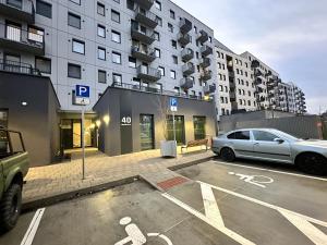 a parking lot with a car parked in front of a building at Nuppu1, free parking, self check-in in Trnávka