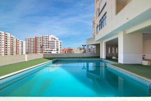 a swimming pool on the roof of a building at Seaside Apartment - Praia da Rocha in Portimão