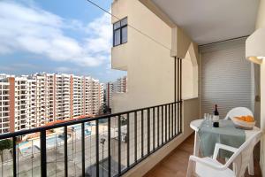 a balcony with a table and a view of a city at Seaside Heaven - Praia da Rocha in Portimão