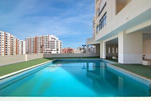 a swimming pool on the roof of a building at Seaside Heaven - Praia da Rocha in Portimão